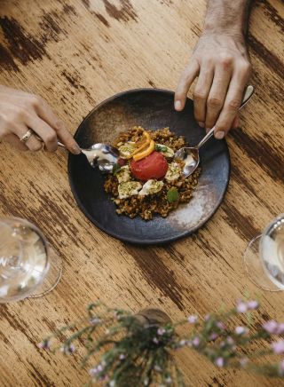 Couple enjoying food and drink at Zecca Restaurant, Griffith